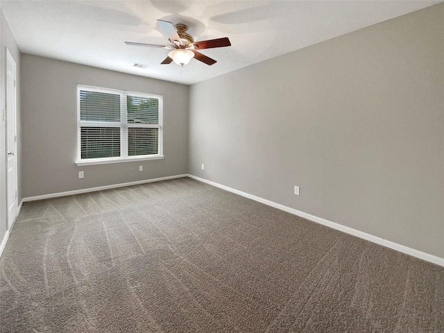 unfurnished room with baseboards, visible vents, ceiling fan, and carpet floors