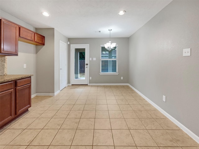 unfurnished dining area featuring visible vents, baseboards, a chandelier, light tile patterned flooring, and recessed lighting