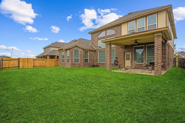 back of property featuring a ceiling fan, brick siding, and a patio