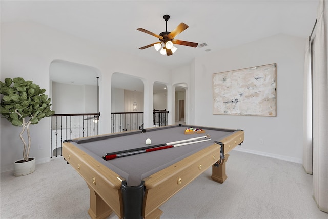 recreation room featuring a ceiling fan, arched walkways, carpet flooring, and baseboards