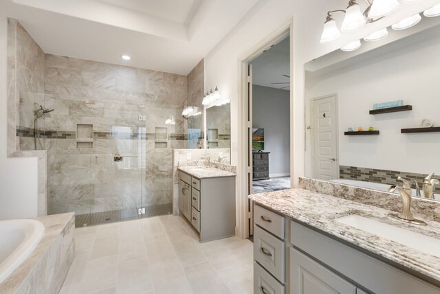 8642 Burdekin Rd, Magnolia, TX 77354 - full bathroom with tiled shower, two vanities, a garden tub, recessed lighting, and tile patterned floors