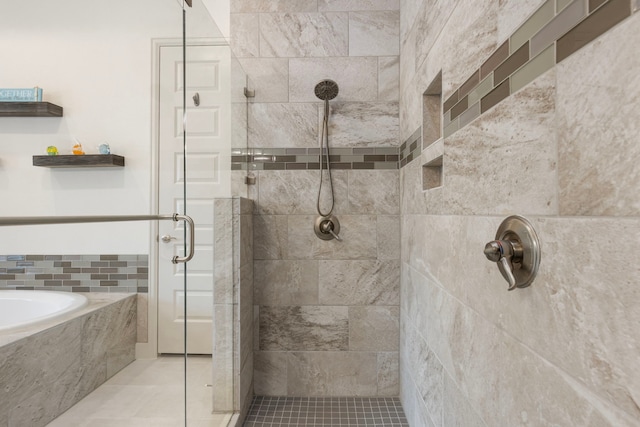 8642 Burdekin Rd, Magnolia, TX 77354 - bathroom featuring a shower stall, a bath, and tile patterned flooring