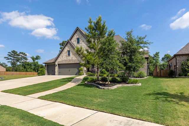 8642 Burdekin Rd, Magnolia, TX 77354 - view of front facade with stone siding, concrete driveway, a garage, and brick siding