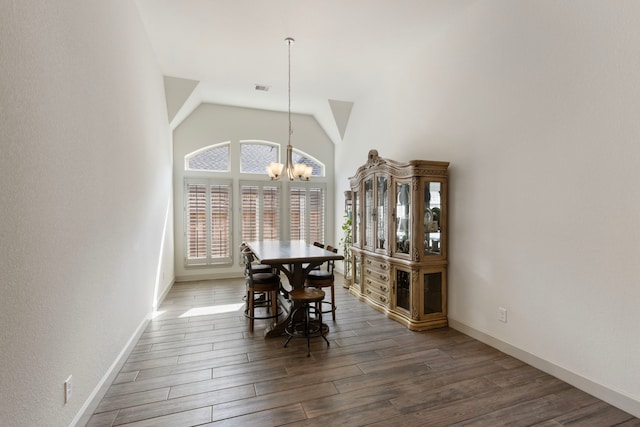 8642 Burdekin Rd, Magnolia, TX 77354 - dining space featuring a chandelier, wood finished floors, baseboards, and high vaulted ceiling