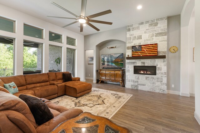 8642 Burdekin Rd, Magnolia, TX 77354 - living area with a ceiling fan, a fireplace, wood finished floors, and baseboards