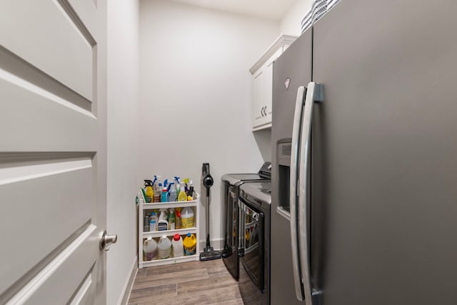 8642 Burdekin Rd, Magnolia, TX 77354 - washroom featuring cabinet space, washing machine and dryer, wood finished floors, and baseboards