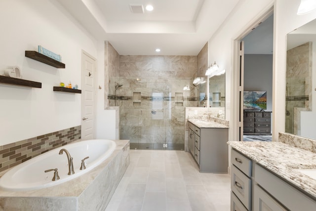 8642 Burdekin Rd, Magnolia, TX 77354 - full bath with a walk in shower, a bath, two vanities, tile patterned flooring, and a raised ceiling