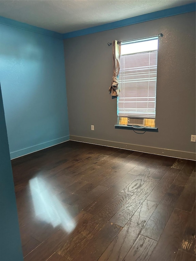 301 Rd 5232, Cleveland, TX 77327 - spare room with baseboards, dark wood-style flooring, and cooling unit