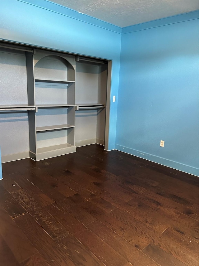 301 Rd 5232, Cleveland, TX 77327 - unfurnished bedroom with baseboards, dark wood finished floors, and a closet
