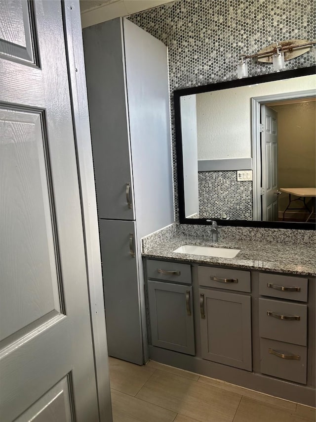 301 Rd 5232, Cleveland, TX 77327 - bathroom with tile patterned floors, vanity, and backsplash