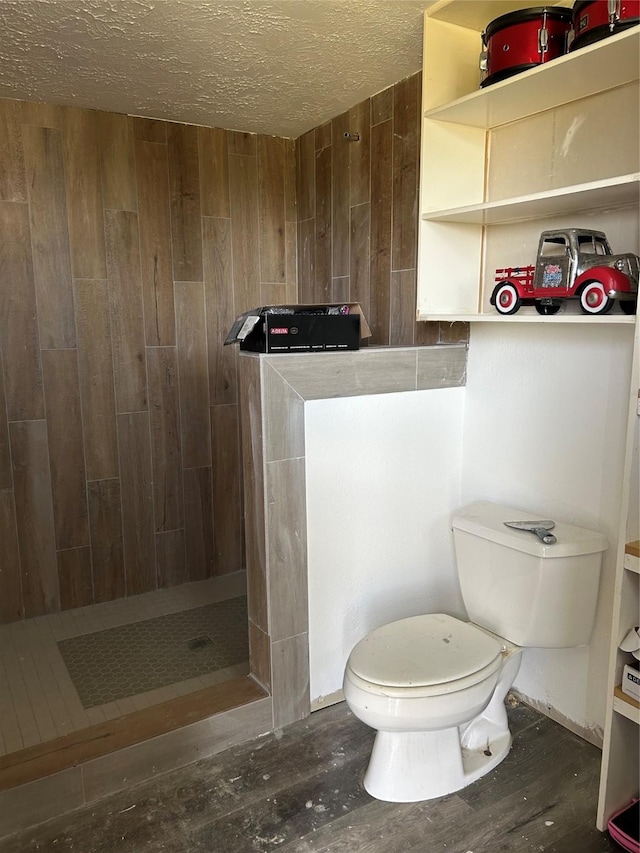 301 Rd 5232, Cleveland, TX 77327 - bathroom featuring a stall shower, toilet, wood finished floors, and wood walls