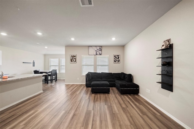 327 Pecos Dr, Huntsville, TX 77340 - living room featuring wood finished floors, recessed lighting, and baseboards