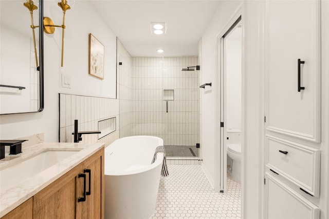 5502 Graystone Ln, Houston, TX 77069 - bathroom with toilet, a freestanding bath, a shower stall, vanity, and recessed lighting