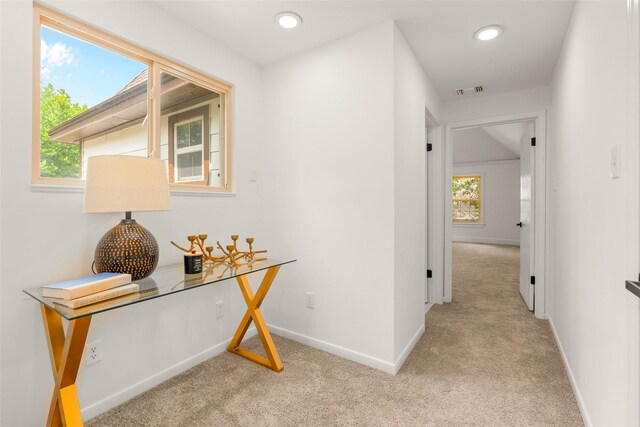 5502 Graystone Ln, Houston, TX 77069 - hallway with baseboards, a healthy amount of sunlight, and light colored carpet