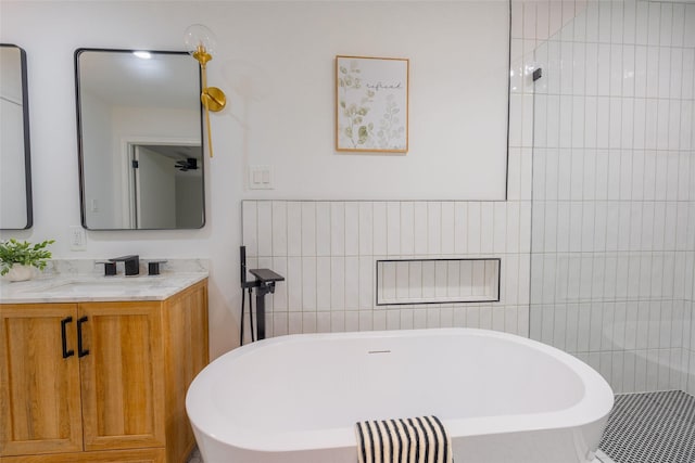 5502 Graystone Ln, Houston, TX 77069 - full bathroom with vanity, tile walls, and a freestanding bath