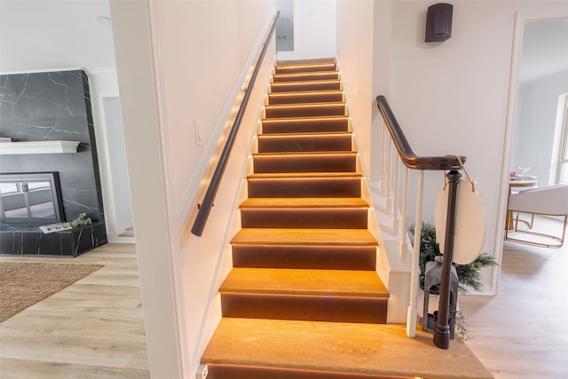 5502 Graystone Ln, Houston, TX 77069 - stairway with a large fireplace and wood finished floors