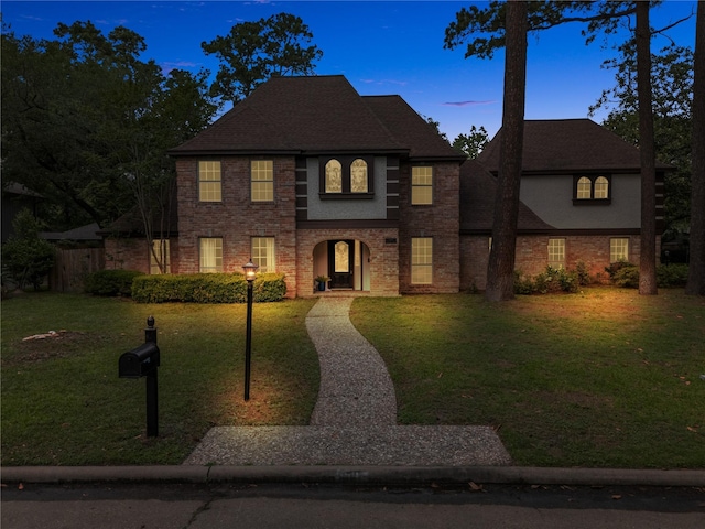 5502 Graystone Ln, Houston, TX 77069 - view of front facade featuring brick siding, a front lawn, and fence