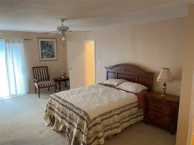 bedroom with carpet, a textured ceiling, and a ceiling fan