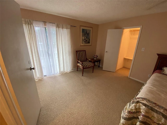 carpeted bedroom with a textured ceiling and baseboards