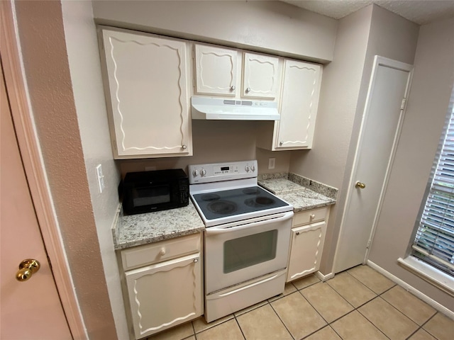 kitchen with white electric range oven, under cabinet range hood, light tile patterned floors, and white cabinets