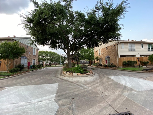 view of concrete street featuring curbs