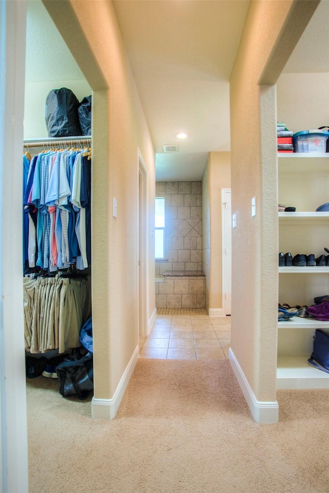 1634 Topaz Trl, Willis, TX 77378 - hallway featuring carpet flooring, tile patterned flooring, and baseboards