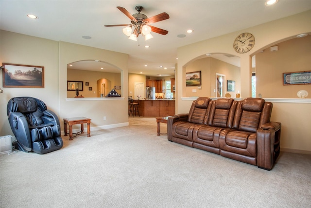 1634 Topaz Trl, Willis, TX 77378 - living room featuring light colored carpet, ceiling fan, recessed lighting, baseboards, and arched walkways