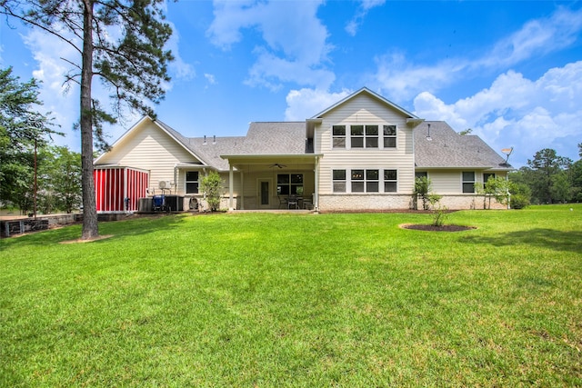 1634 Topaz Trl, Willis, TX 77378 - back of property with ceiling fan, a yard, a shingled roof, and a patio area