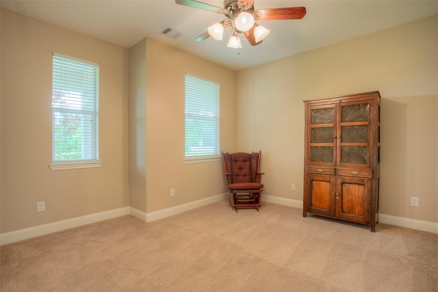 1634 Topaz Trl, Willis, TX 77378 - living area with a ceiling fan, light carpet, and baseboards