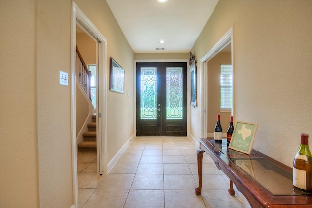 1634 Topaz Trl, Willis, TX 77378 - foyer entrance featuring french doors, light tile patterned flooring, stairs, and baseboards