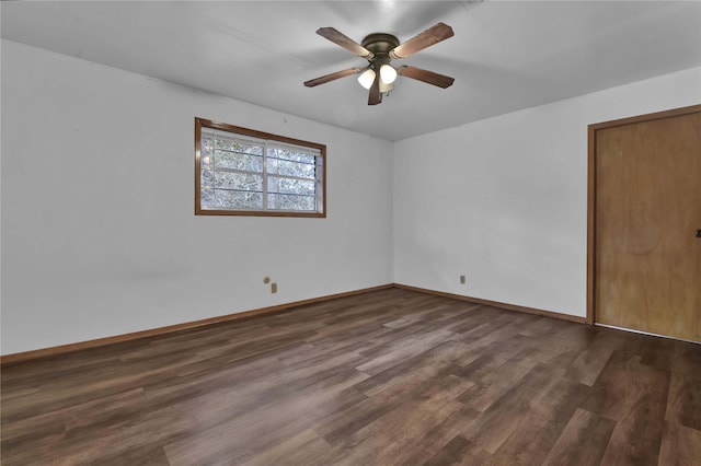 unfurnished room featuring baseboards, ceiling fan, and dark wood-style floors