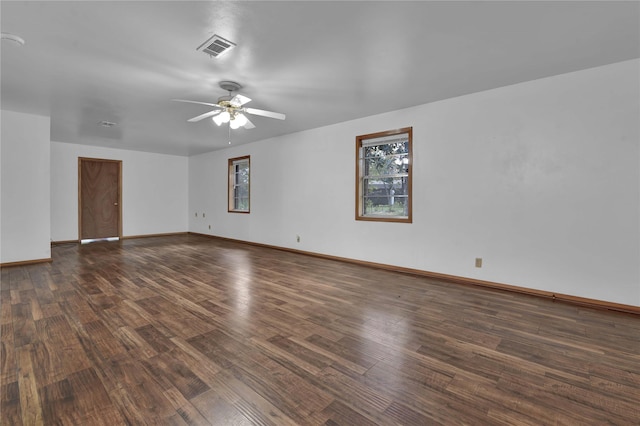 unfurnished room with baseboards, a ceiling fan, visible vents, and wood finished floors