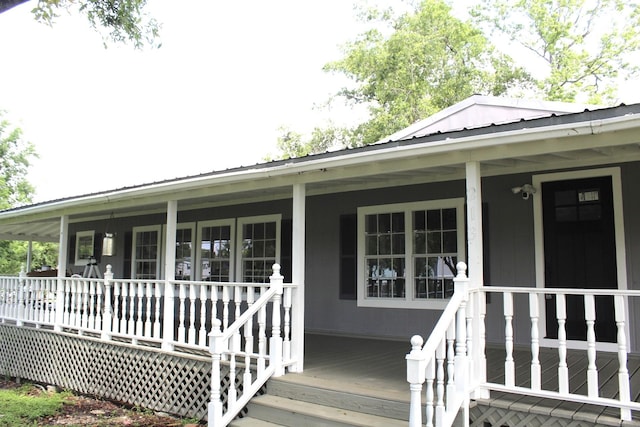 213 Red Haven Dr, Highlands, TX 77562 - entrance to property with covered porch and metal roof