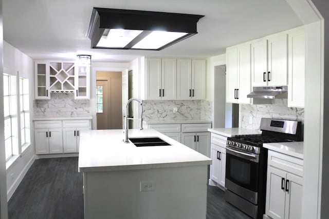 213 Red Haven Dr, Highlands, TX 77562 - kitchen featuring stainless steel gas stove, a sink, under cabinet range hood, decorative backsplash, and plenty of natural light