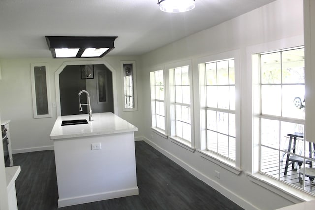 213 Red Haven Dr, Highlands, TX 77562 - kitchen with a sink, baseboards, dark wood-style flooring, and light countertops