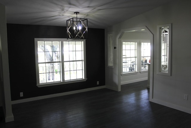 213 Red Haven Dr, Highlands, TX 77562 - unfurnished dining area with baseboards, healthy amount of natural light, dark wood finished floors, and arched walkways