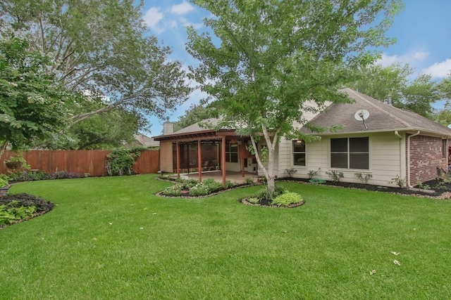 back of house featuring a patio, a chimney, fence, a shingled roof, and a yard