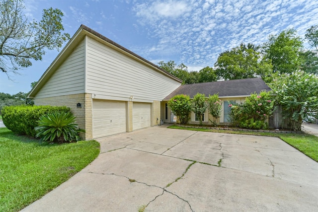 2122 Clemson Dr, Katy, TX 77493 - view of property exterior with a yard, brick siding, driveway, and a garage