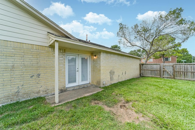 2122 Clemson Dr, Katy, TX 77493 - doorway to property with a gate, fence, french doors, brick siding, and a yard