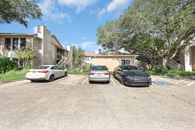 view of front of property with uncovered parking and stairway