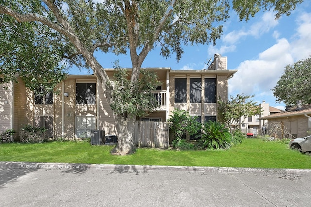 view of front of house featuring a chimney and a front yard