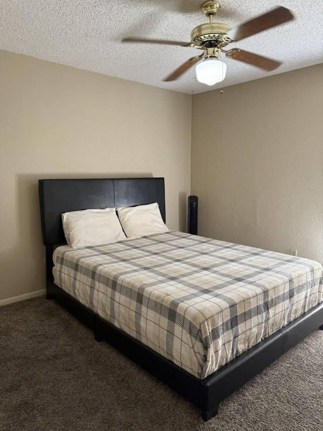 bedroom featuring ceiling fan, a textured ceiling, and carpet