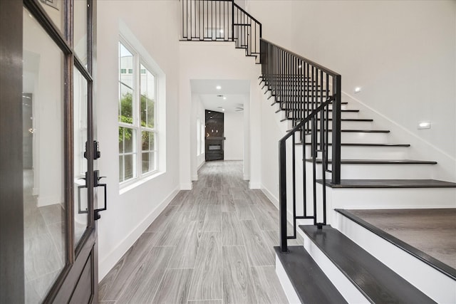 10935 Brookeshire Chase Ln, Houston, TX 77043 - foyer with stairway, wood finished floors, baseboards, and a high ceiling