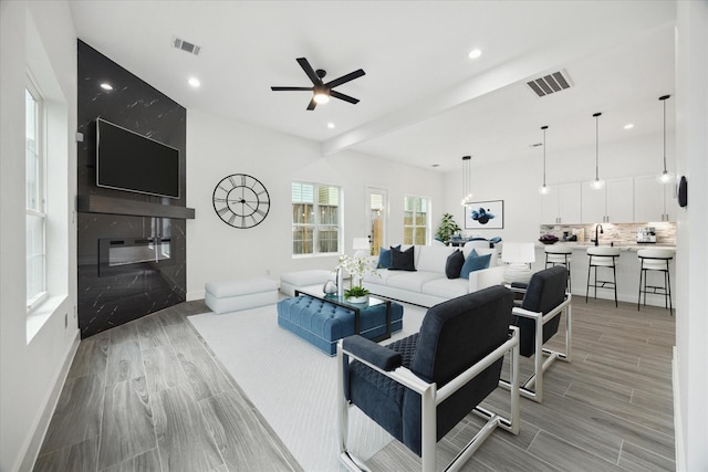 10935 Brookeshire Chase Ln, Houston, TX 77043 - living room featuring ceiling fan, light wood-style floors, baseboards, recessed lighting, and a fireplace
