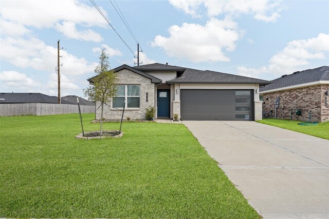 30102 Reagans Ranch Dr, Katy, TX 77494 - view of front of property featuring a garage, fence, concrete driveway, a front yard, and brick siding