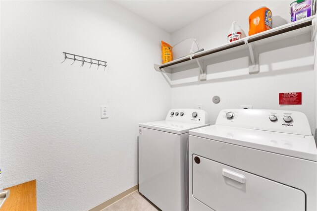 30102 Reagans Ranch Dr, Katy, TX 77494 - laundry area featuring separate washer and dryer, laundry area, light tile patterned floors, and baseboards