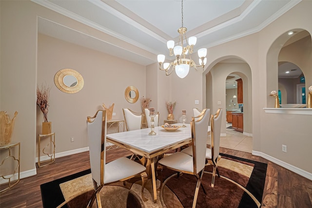 122 Marble Staff Ct, Houston, TX 77069 - dining space with light wood-type flooring, baseboards, arched walkways, crown molding, and a chandelier