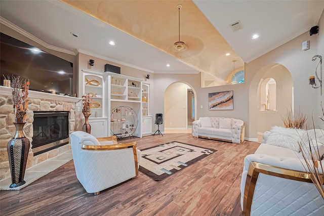 122 Marble Staff Ct, Houston, TX 77069 - living area with arched walkways, crown molding, wood finished floors, baseboards, and a fireplace