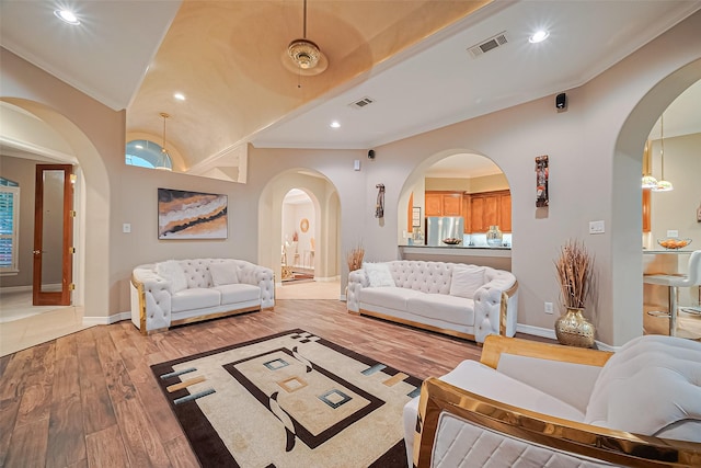 122 Marble Staff Ct, Houston, TX 77069 - living room featuring arched walkways, light wood-type flooring, baseboards, recessed lighting, and ornamental molding