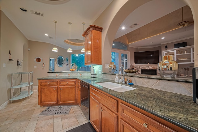 122 Marble Staff Ct, Houston, TX 77069 - kitchen featuring a sink, a peninsula, arched walkways, brown cabinetry, and dark stone counters